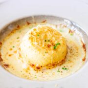 Pin Image: Twice baked cheese soufflé in beige dish with text overlaid
