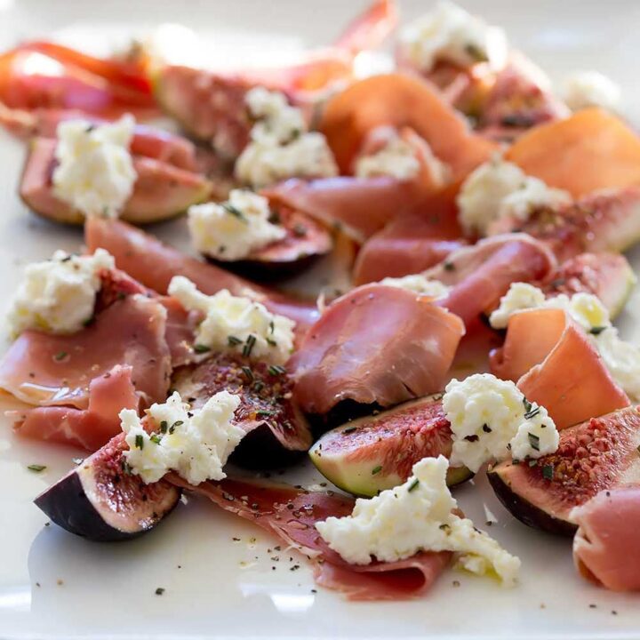 Prosciutto and fig salad close-up so you can see the oil and herbs
