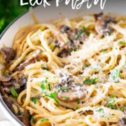 Pin Image: Mushroom and leek pasta in a cream cast iron pan with text overlaid
