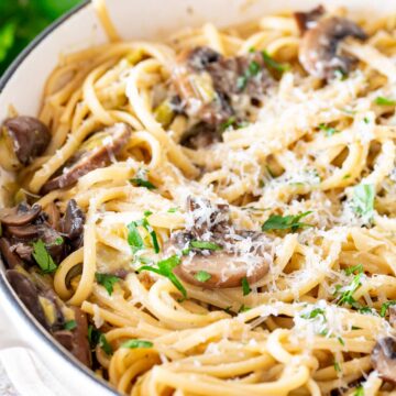 Mushroom and leek pasta with parmesan cooked in a cream cast iron pan