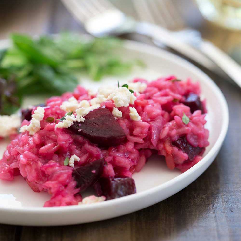 chunks in beetroot in a pink risotto with white ricotta and thyme on top
