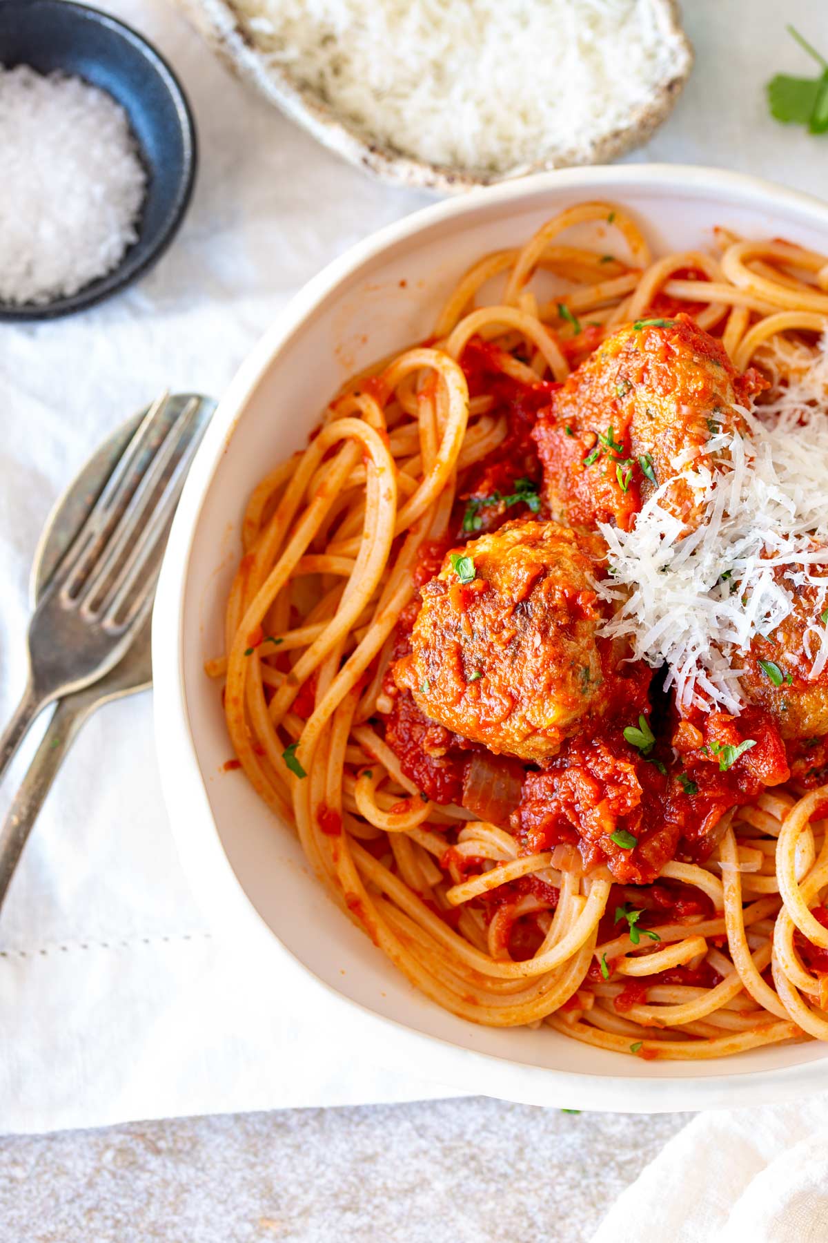 Close-up of spaghetti and chicken meatballs in rich tomato sauce