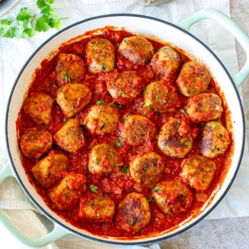 overhead of a skillet full of meatballs in tomato sauce