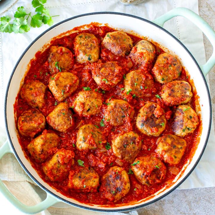overhead of a skillet full of meatballs in tomato sauce