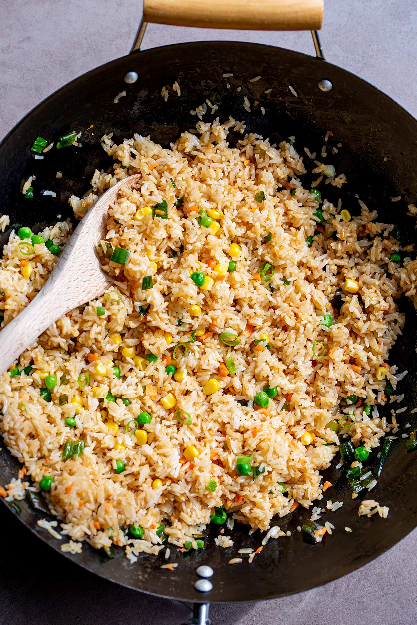 overhead shot of a black wok filled with rice and vegetables