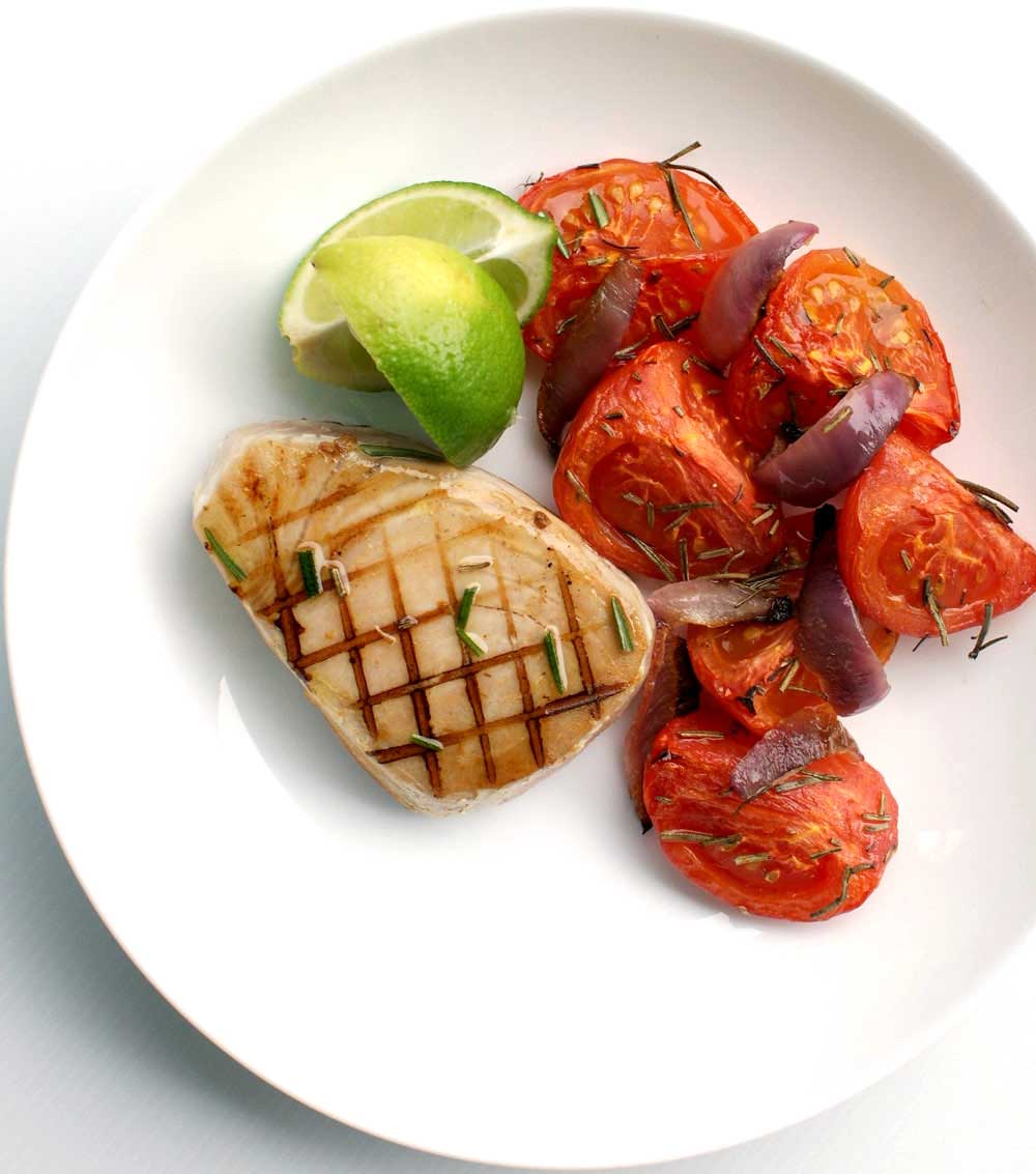Seared Tuna with Roasted Rosemary Tomatoes - recipe. Rosemary, lime and garlic are used to marinate the fresh tuna, served with sweet roasted tomatoes