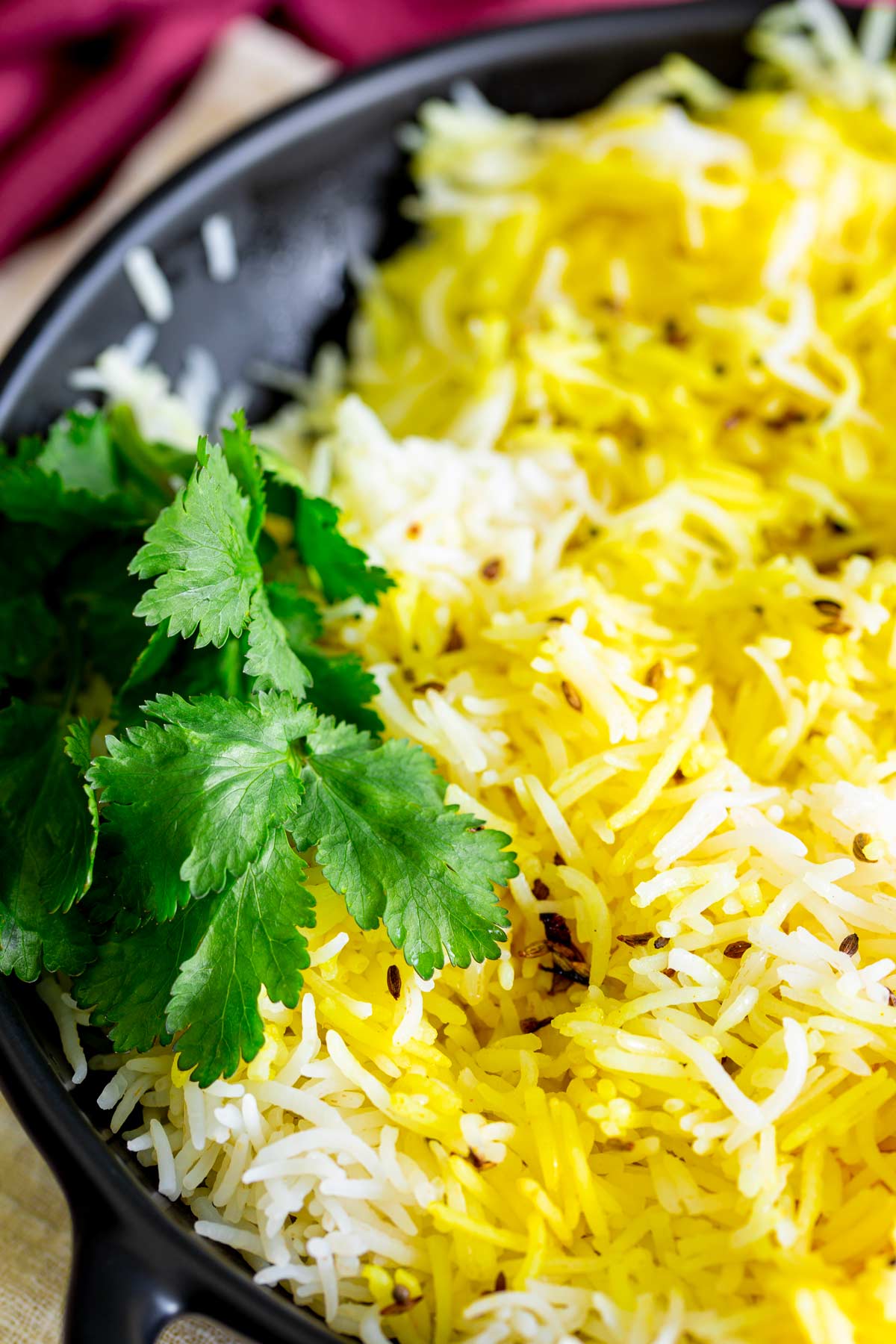 cilantro garnishing a bowl of yellow and rice Indian basmati rice