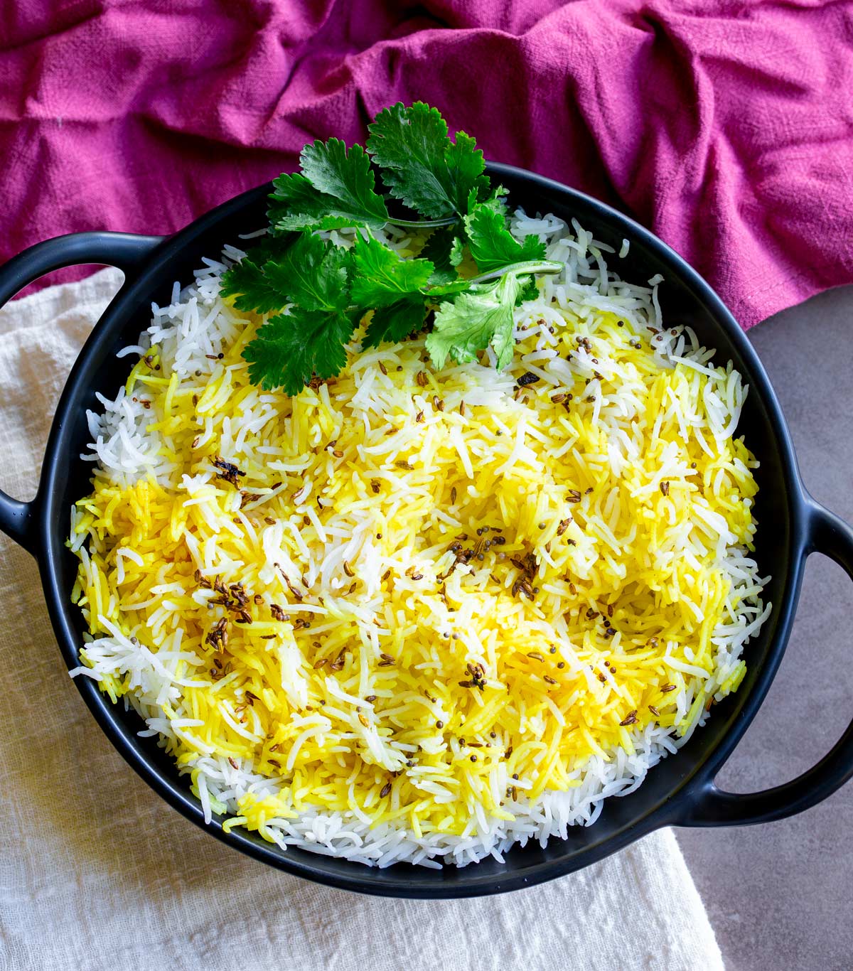 white and yellow basmati rice in a black bowl