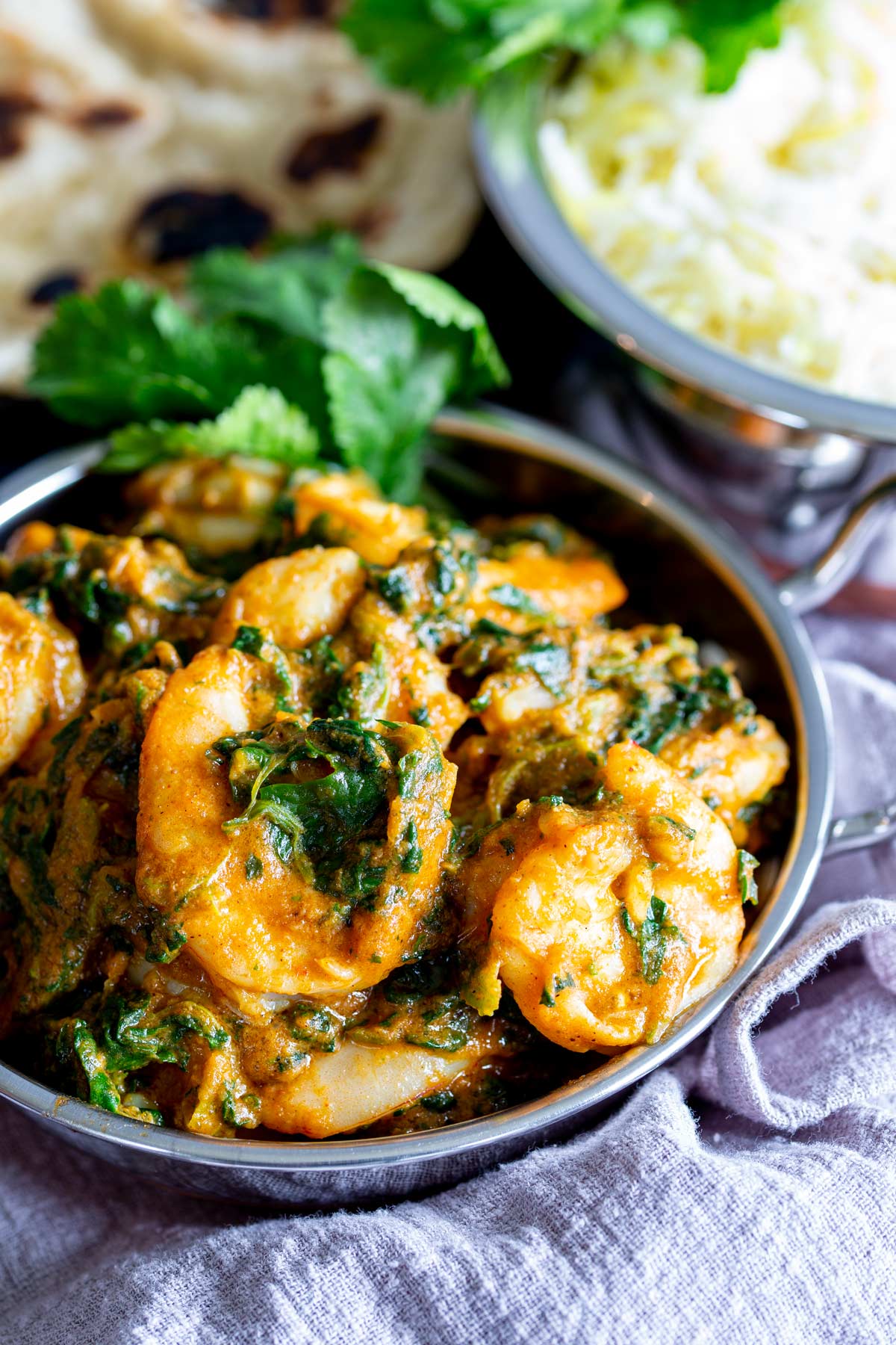 shrimp and spinach in a silver bowl